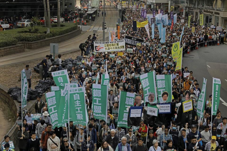 Thousands of people march on the first day of 2017 at a downtown street in Hong Kong Sunday, Jan. 1, 2017, to protest against Beijing's interpretation of Basic Law and Hong Kong government's bid to ban pro-democracy lawmakers from taking office. They also demand true universal suffrage, which is not happening in the coming chief executive election in March. (AP Photo/Vincent Yu)