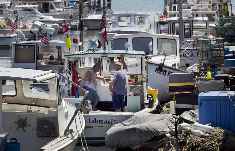 Lobstermen take a break while doing maintenance work, Thursday, August 9, 2012, in Portland, Maine. Plentiful lobsters this season has depressed the prices that lobstermen have been getting, to below $3 a pound. In recent weeks Maine lobstermen stayed off the water for several days to try to let the market rebound. (AP Photo/Robert F. Bukaty)