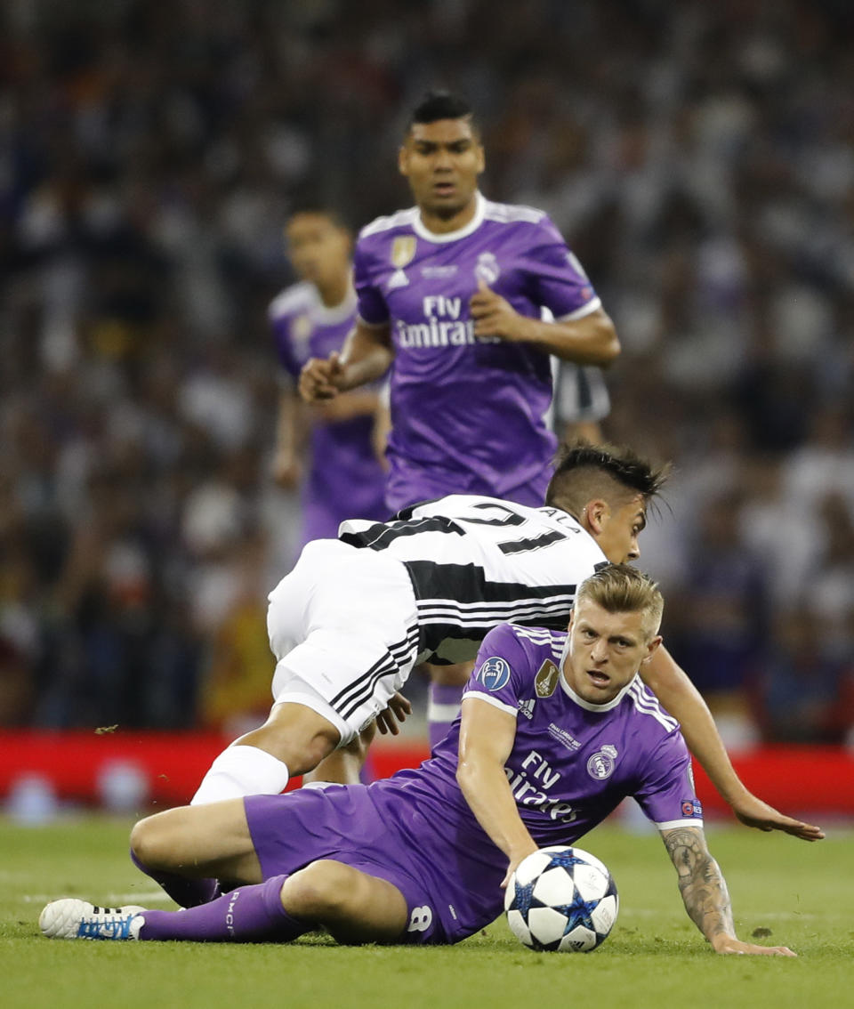 <p>Real Madrid’s Toni Kroos, front, and Juventus’ Paulo Dybala compete for the ball during the Champions League final soccer match between Juventus and Real Madrid at the Millennium stadium in Cardiff, Wales Saturday June 3, 2017. (AP Photo/Frank Augstein) </p>