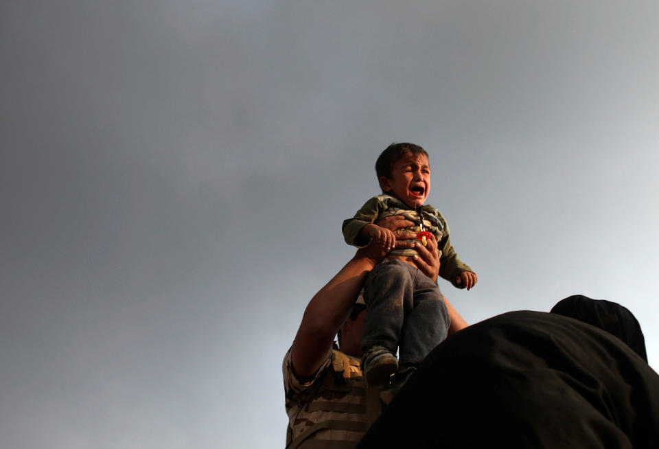 A newly displaced boy cries