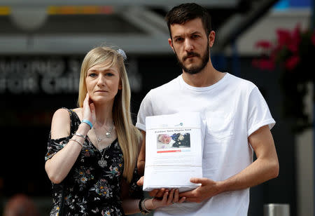 Connie Yates and Chris Gard, pose for the media with a petition, outside Great Ormond Street Hospital, in central London, Britain July 9, 2017. REUTERS/Peter Nicholls