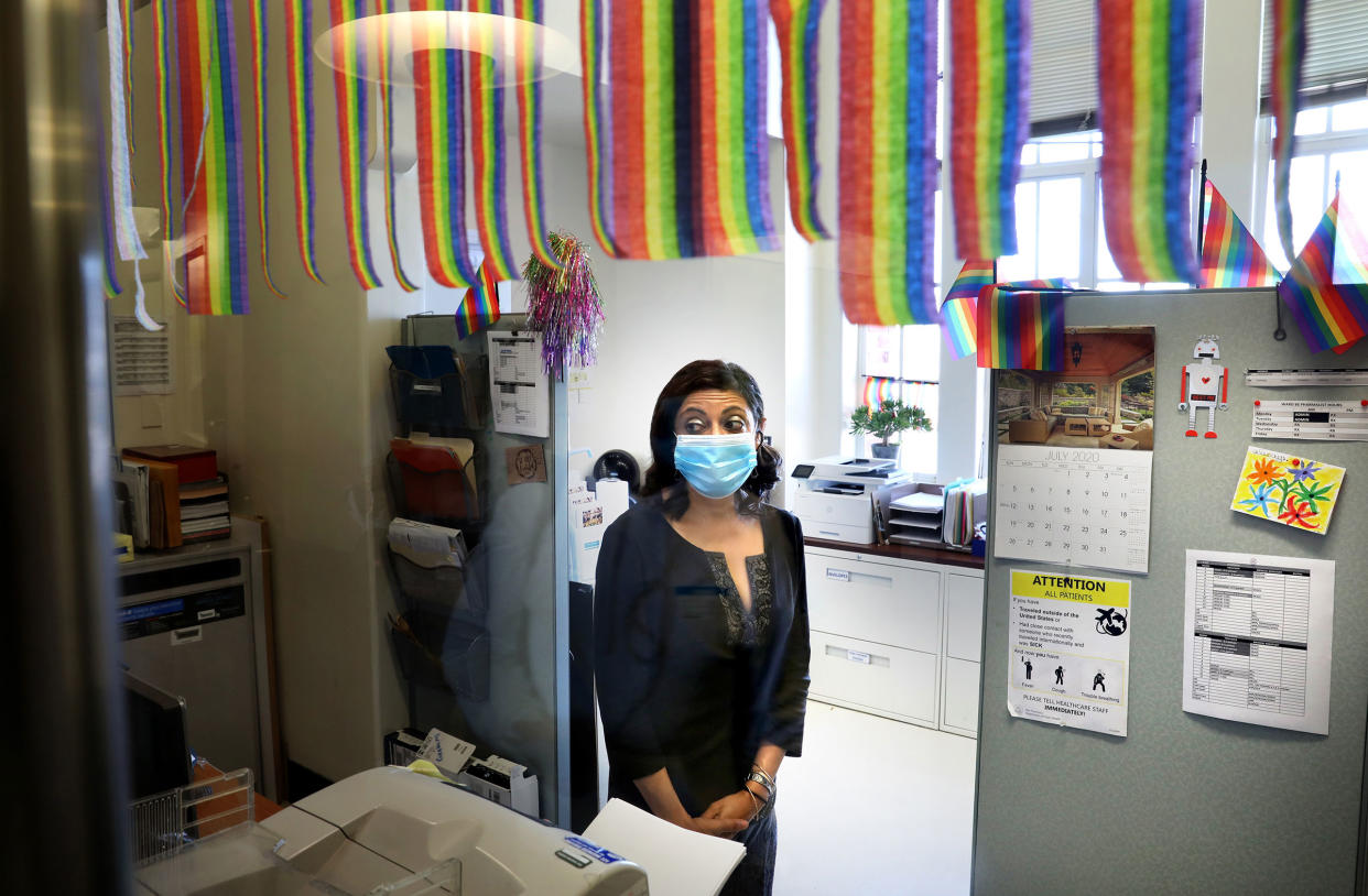 Medical director of Ward 86 at San Francisco General, Monica Gandhi, watches as patients get off the elevator on July 2, 2020.