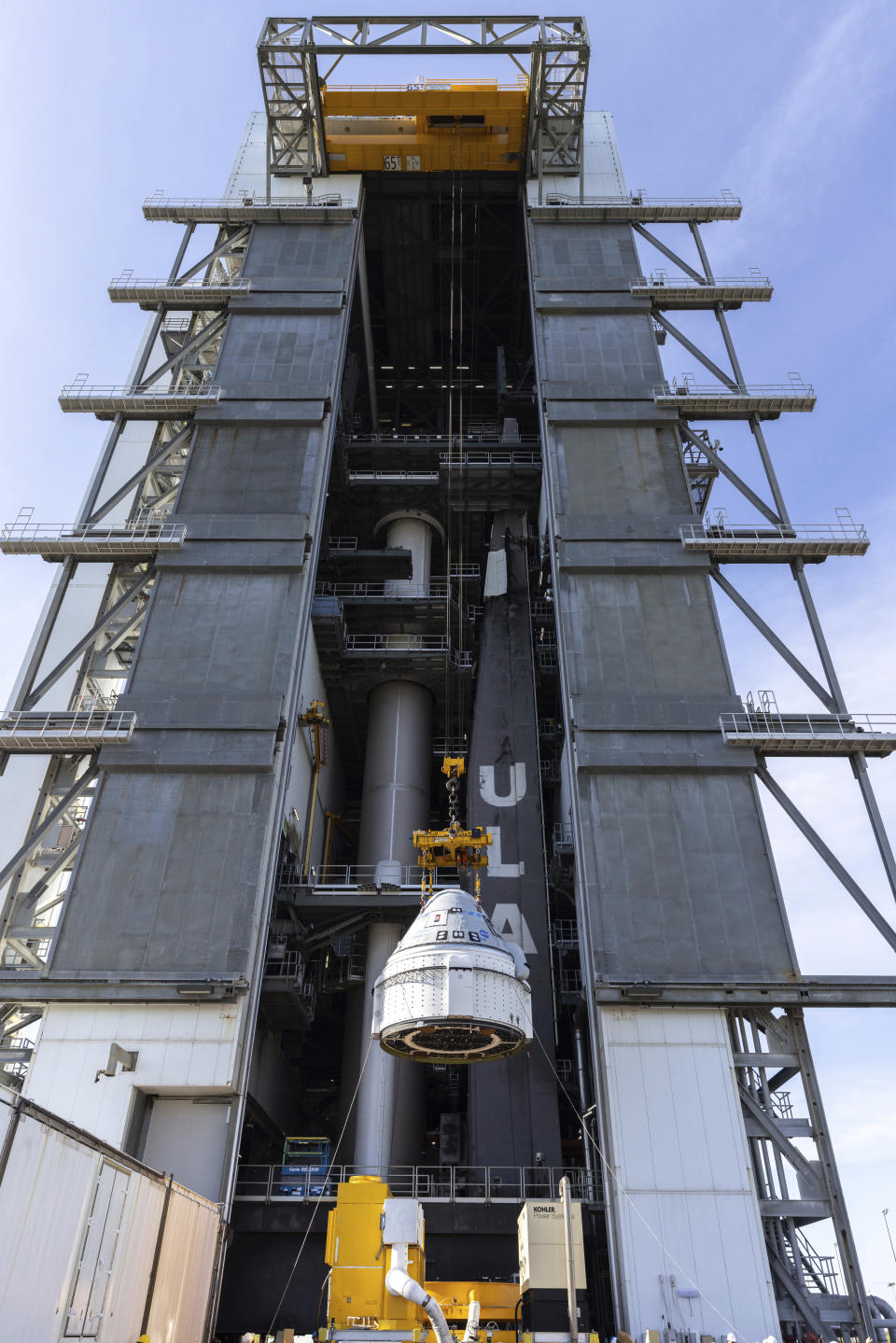 In this photo provided by NASA, the Boeing Starliner spacecraft is lifted at the Vertical Integration Facility at Space Launch Complex-41 at Cape Canaveral Space Force Station in Florida on Tuesday, April 16, 2024, for mounting on a United Launch Alliance Atlas V rocket for NASA's Boeing Crew Flight Test to the International Space Station for the agency's Commercial Crew Program. The first flight of Boeing’s Starliner capsule with a crew on board is scheduled for Monday, May 6, 2024. (Kim Shiflett/NASA via AP)