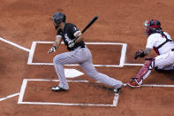 Chicago White Sox's Jose Abreu, left, grounds into a fielder's choice, allowing White Sox's Nick Madrigal to score, as Boston Red Sox's Christian Vazquez, right, looks on in the first inning of a baseball game, Sunday, April 18, 2021, in Boston. The game is the second of a doubleheader Sunday. (AP Photo/Steven Senne)