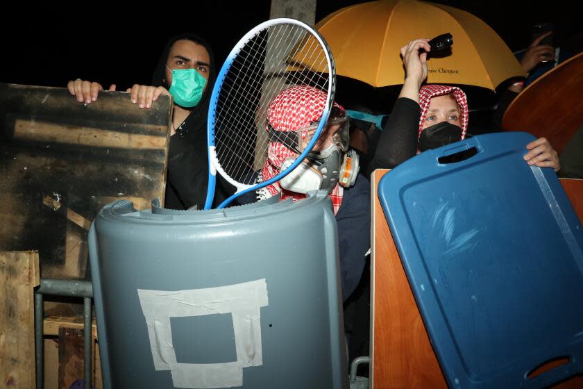 Los Angeles, CA - April 30: Barricades surround the encampment for the pro-Palestine group as they stand guard and keep watch of their encampment from the pro-Israel group at UCLA on Tuesday, April 30, 2024 in Los Angeles, CA. (Michael Blackshire / Los Angeles Times)