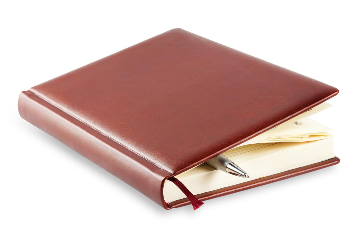Brown leather journal with a pen inside