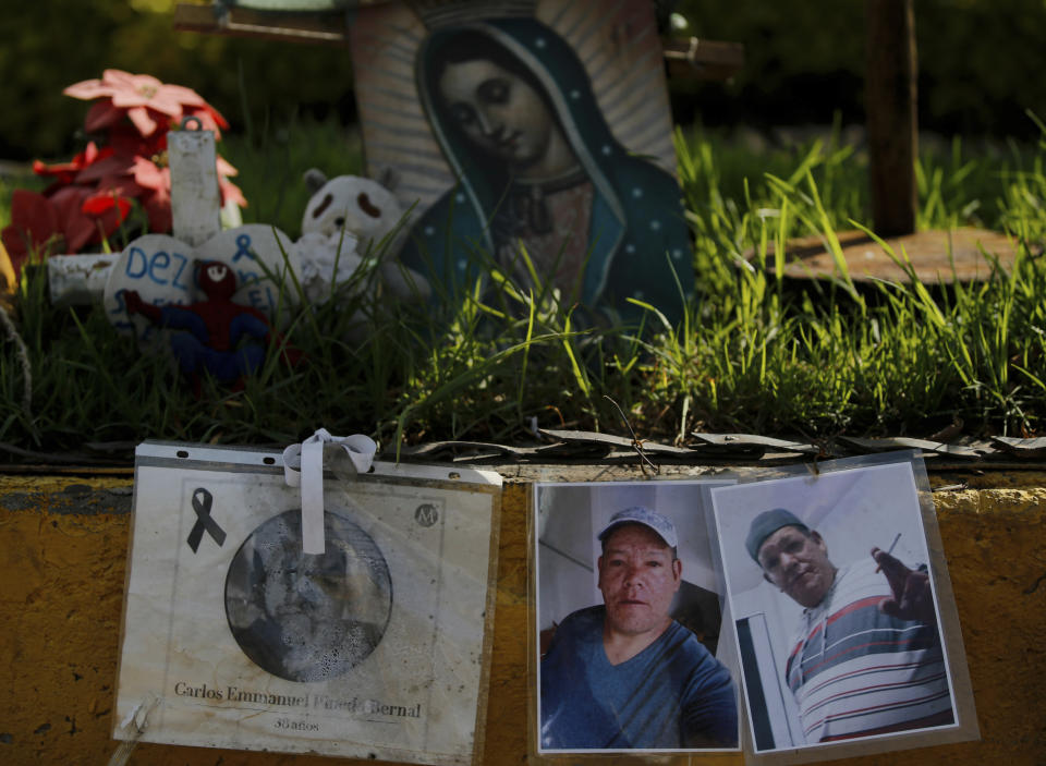 Photos of people who died in a metro collapse hang at the site of the now missing section in Mexico City, Wednesday, June 16, 2021. A June 16, 2021 preliminary report by experts into the collapse that killed 26 people placed much of the blame on poor welds in studs that joined steel support beams to a concrete layer supporting the trackbed. (AP Photo/Fernando Llano)