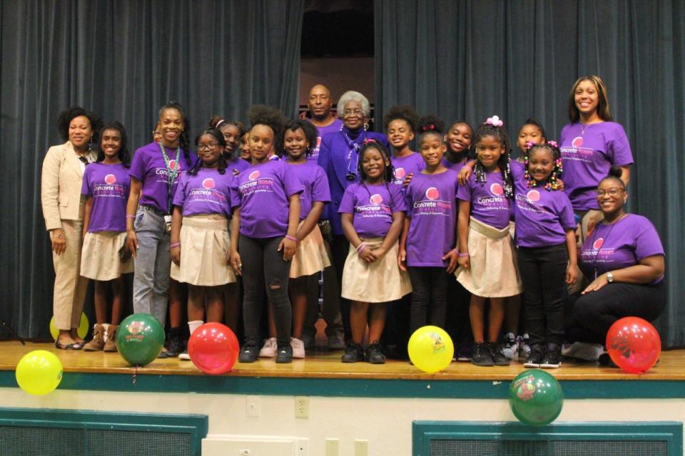 The Concrete Roses Mentoring Program and historian Lizzie Robinson-Jenkins, center, pose for a picture after hosting its Black History Month program.
(Photo: Photo by Voleer Thomas/For The Guardian)