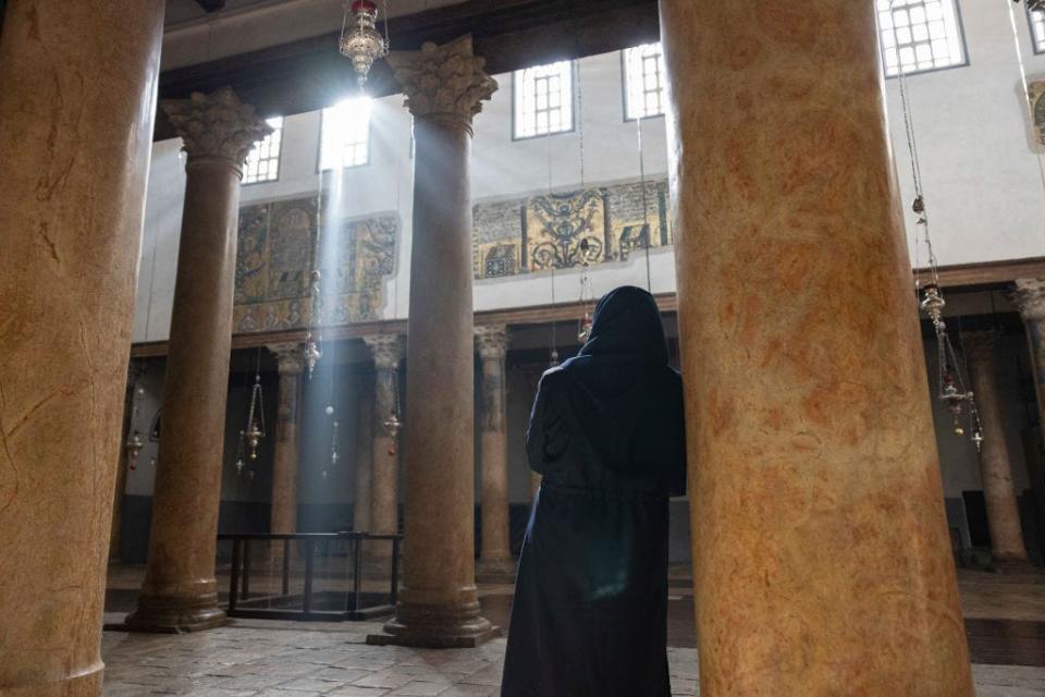 A worshiper stands in empty Church of Nativity in Bethlehem