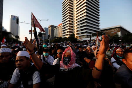 Protester gestures during a protest across the Election Supervisory Agency (Bawaslu) headquarters following the announcement of the last month's presidential election results in Jakarta, Indonesia, May 22, 2019. REUTERS/Willy Kurniawan