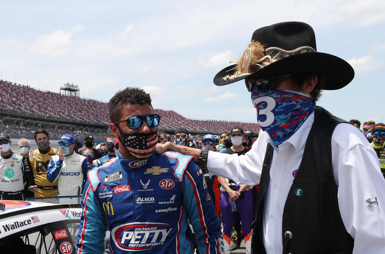 TALLADEGA, ALABAMA - JUNE 22: Bubba Wallace, driver of the #43 Victory Junction Chevrolet, and NASCAR Hall of Famer and team owner Richard Petty look on after NASCAR drivers pushed Wallace to the front of the grid as a sign of solidarity with the driver prior to the NASCAR Cup Series GEICO 500 at Talladega Superspeedway on June 22, 2020 in Talladega, Alabama. A noose was found in the garage stall of NASCAR driver Bubba Wallace at Talladega Superspeedway a week after the organization banned the Confederate flag at its facilities. (Photo by Chris Graythen/Getty Images)