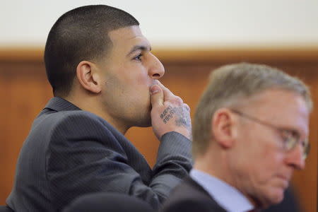 Former New England Patriots football player Aaron Hernandez (L) and his attorney Charles Rankin listen as prosecution witness Alexander Bradley is questioned by the prosecution without the jury present at Bristol County Superior Court in Fall River, Massachusetts April 1, 2015. REUTERS/Brian Snyder