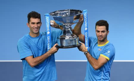 Tennis - Barclays ATP World Tour Finals - O2 Arena, London - 22/11/15 Men's Doubles - Netherlands' Jean Julien Rojer (R) and Romania's Horia Tecau celebrate with the trophy after winning the final Action Images via Reuters / Tony O'Brien