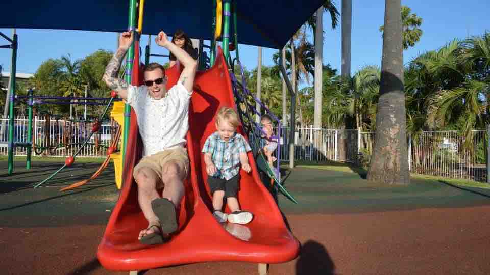 Blake Hann going down a slide with one of his sons.