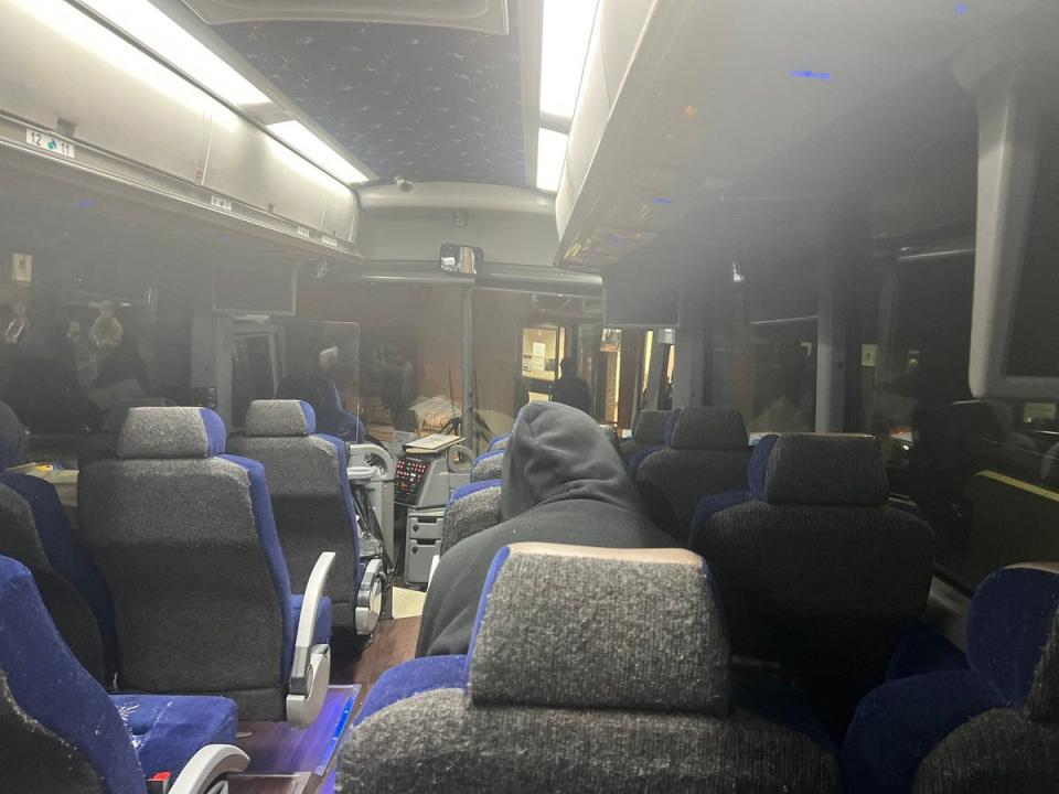 view of inside of greyhound bus with lights on