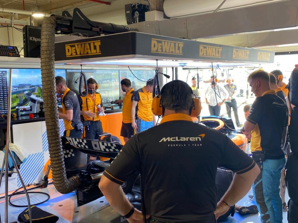 McLaren Racing CEO Zak Brown looks on as his team works on Daniel Ricciardo's car during the first practice of the Miami Grand Prix.