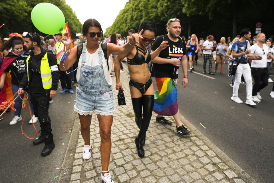 Revelers dance as take part in the annual pride march in Berlin, Germany, Saturday, July 23, 2022. Draped in rainbow flags, around 150,000 people were marching for LGBTQ rights at Berlin's annual Christopher Street Day celebration. Berlin police gave the crowd estimate on Saturday afternoon but said the number could grow into the evening. (AP Photo/Markus Schreiber)