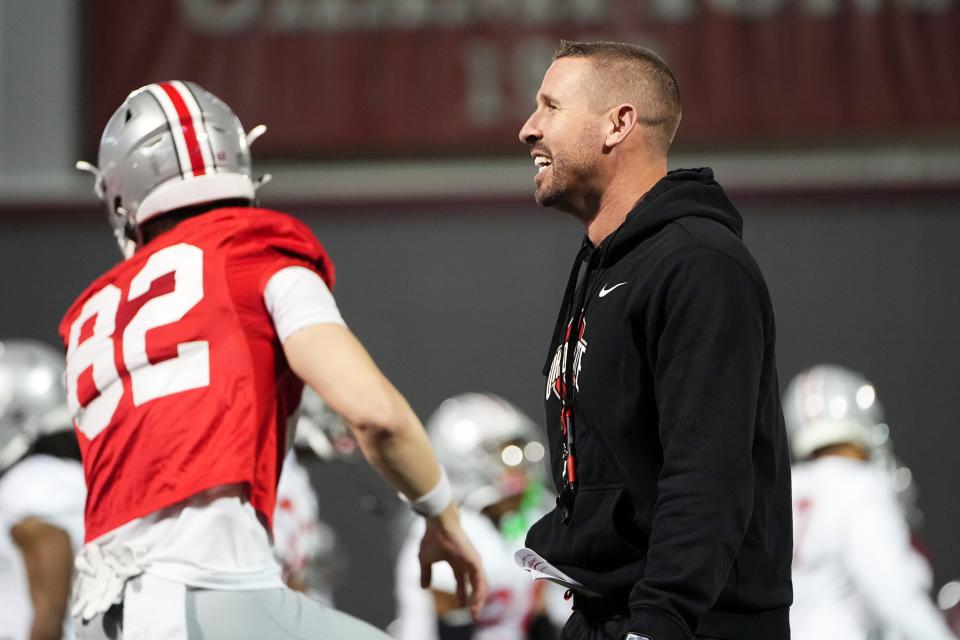 Mar 7, 2024; Columbus, OH, USA; Ohio State Buckeyes co-offensive coordinator Brian Hartline watches players warm up during spring football practice at the Woody Hayes Athletic Center.