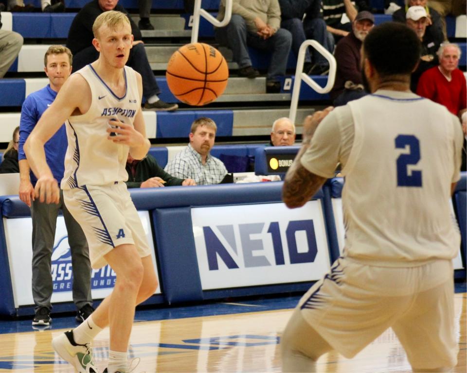 Former Bishop Connolly standout and 2018-19 Herald News Boys Basketball Player of the Year and current Assumption junior Cooper Creek passes to teammate Isiah Gaiter during  game against St. Michael’s College.