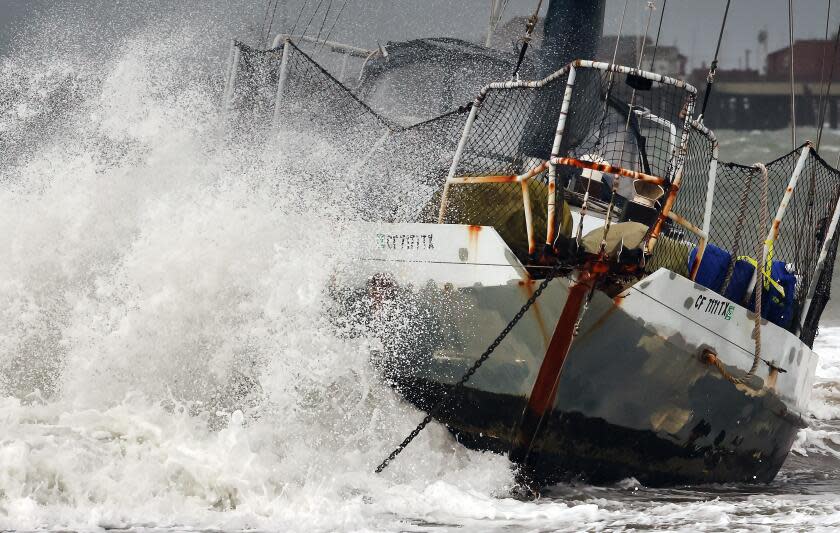 SANTA BARBARA, CALIFORNIA - FEBRUARY 04: A wave hits a boat which washed ashore as a powerful long-duration atmospheric river storm, the second in less than a week, impacts California on February 4, 2024 in Santa Barbara, California. The storm is delivering potential for widespread flooding, landslides and power outages while dropping heavy rain and snow across the region. (Photo by Mario Tama/Getty Images)