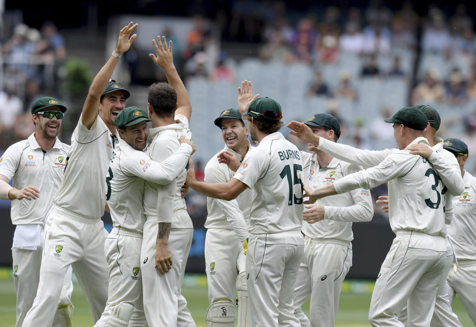 Australia players celebrate with James Pattinson after capturing the wicket of New Zealand's BJ Watling during a cricket test match in Melbourne, Australia, Saturday, Dec. 28, 2019. (AP Photo/Andy Brownbill)