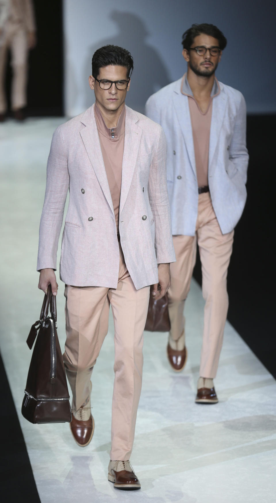 Models wear creations for Giorgio Armani men's Spring-Summer 2014 collection, part of the Milan Fashion Week, unveiled in Milan, Italy, Tuesday, June 25, 2013. (AP Photo/Luca Bruno)