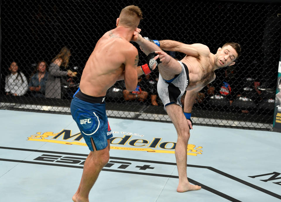 SACRAMENTO, CALIFORNIA - JULY 13:  (R-L) Ryan Hall kicks Darren Elkins in their featherweight bout during the UFC Fight Night event at Golden 1 Center on July 13, 2019 in Sacramento, California. (Photo by Jeff Bottari/Zuffa LLC/Zuffa LLC via Getty Images)