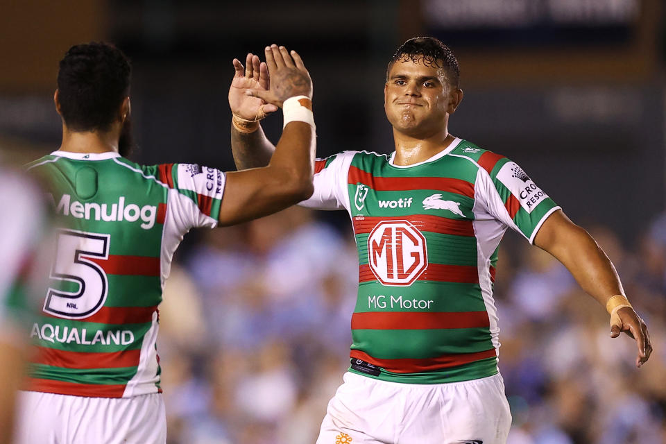 Seen right, Souths star Latrell Mitchell high-fiving teammate Izaac Thompson during the round one win over Cronulla in the NRL.