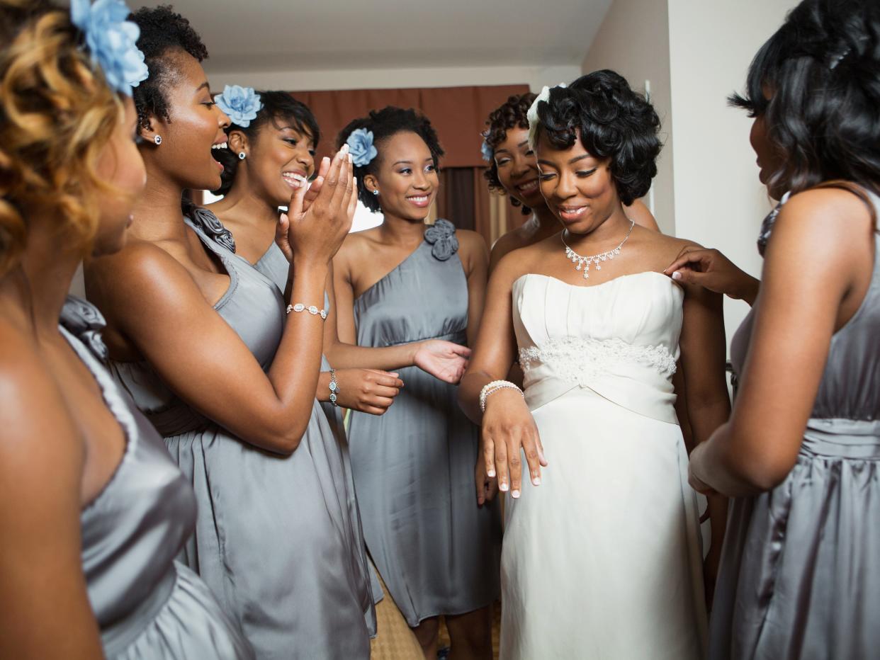 A bride stands with her bridesmaids before the ceremony
