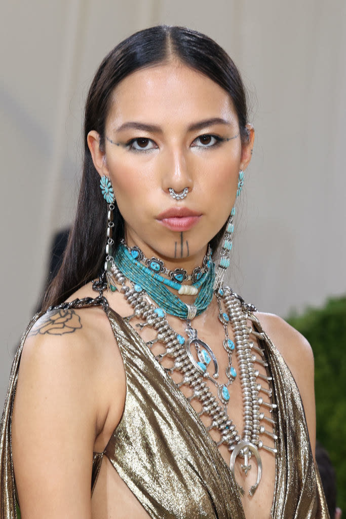Quannah is an Indigenous model (of Hän Gwich’in and Oglala Lakota descent) who made her New York Fashion Week debut right before she hopped onto the scene at the Met. Her face tattoos, called Yidįįłtoo, are a traditional Hän Gwich’in look going back thousands of years. Paired with a Navajo jewelry collection from Jocelyn Billy Upshaw with turquenite and silver pieces, Quannah's glam absolutely won the evening with her look. You can't have an American theme without representation from Indigenous folk!