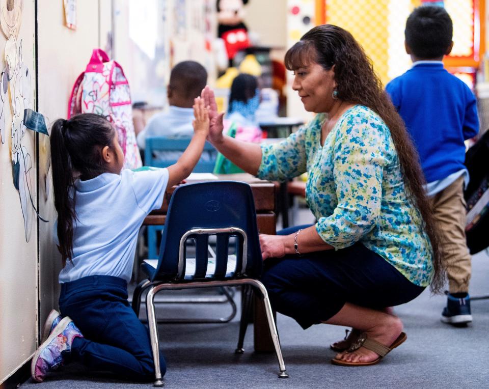 Brewbaker Primary School parent liaison Teresa Elmore, who is bilingual, gets a high five from a Spanish speaking student who was learning her way around on her first day at the school in Montgomery, Ala., on Thursday September 5, 2019.