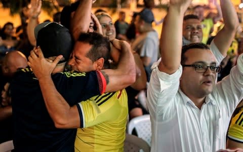 Colombian football fans celebrate in Medellin after they qualified for the World Cup - Credit: AFP