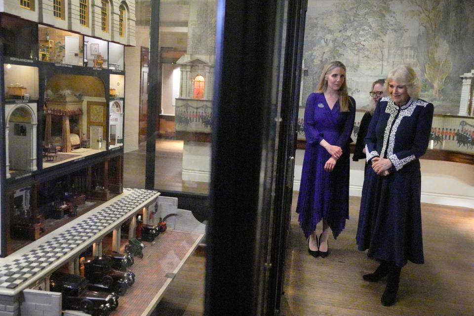 Britain's Queen Camilla looks at Queen Mary's Dolls' House as she hosts a reception at Windsor Castle for authors, illustrators and binders (Getty Images)