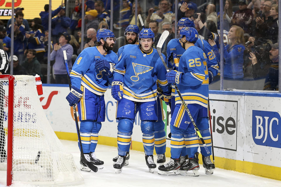 St. Louis Blues' Sammy Blais, center, is congratulated by teammates after scoring against the Colorado Avalanche during the second period of an NHL hockey game Saturday, Feb. 18, 2023, in St. Louis. (AP Photo/Scott Kane)