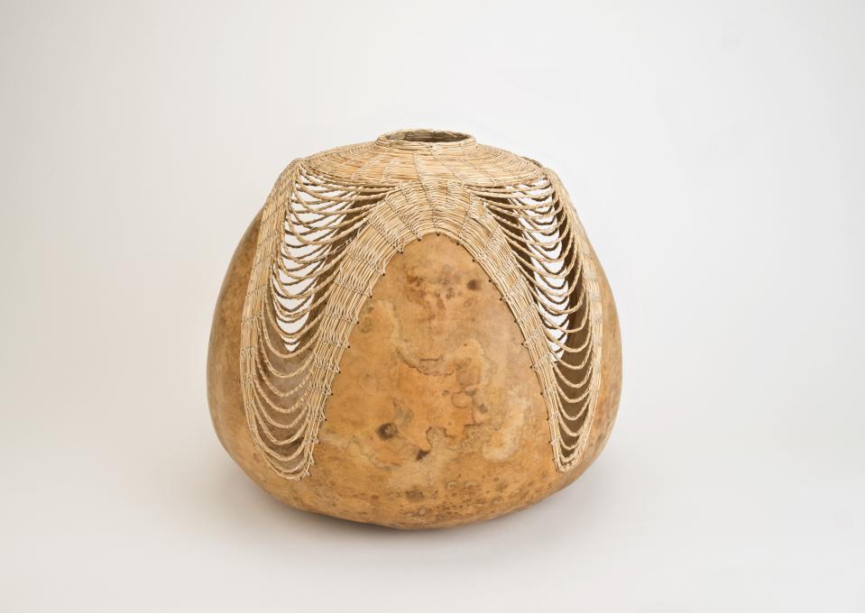 Terrol Dew Johnson (Tohono O’odham, 1973-2024). Untitled, 2001. Gourd, bear grass, 13 ¾ x 15 ¼ inches. Heard Museum purchase, 4116-1.