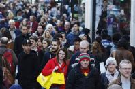 Shoppers walk along Oxford Street on the last Sunday before Christmas in London December 22, 2013. REUTERS/Luke MacGregor