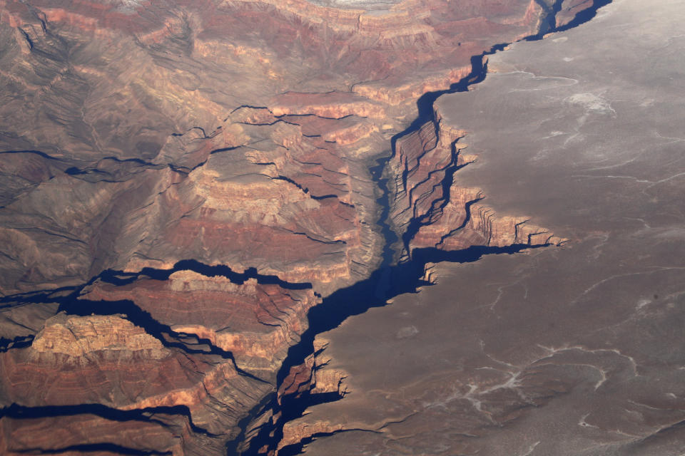 FILE - Arizona's Grand Canyon is seen in this aerial photo Dec. 17, 2019. A visit from President Joe Biden to Arizona this week is creating buzz that longtime advocates for banning mining on land around the Grand Canyon could be getting their wish. Biden’s first stop Tuesday will be near the Grand Canyon, where he’s expected to announce plans for a new national monument to preserve more than 1,562 square miles. (AP Photo/Charlie Riedel, File)