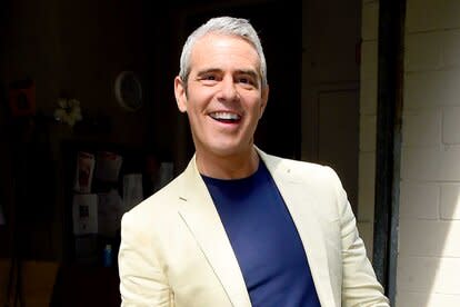 Andy Cohen smiles on the street