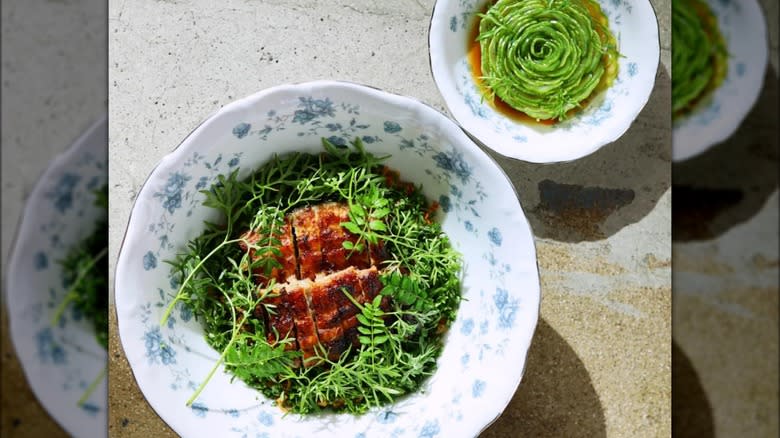 Pork with greens in bowls