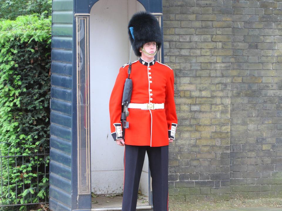 A Grenadier Guard stands at attention at the entrance to Clarence House in Stable Yard Road, London. 1 June 2012