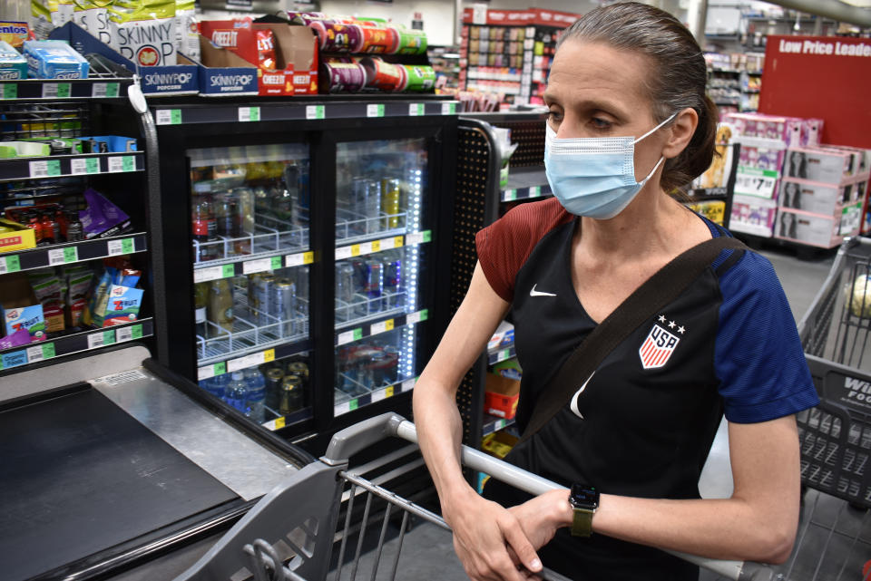 Crystal Dvorak shops at WinCo Foods, Saturday, May, 7, 2021, in Billings, Mont. Dvorak recently lost her job as an audiologist. The day Montana Gov. Greg Gianforte announced the $300 benefit would end June 27 was Dvorak’s second day of unemployment. (AP Photo/Matthew Brown)