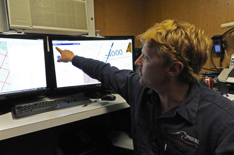 A photo taken on April 16, 2014, and released on April 17, 2014, shows Craig Turner from Phoenix International monitoring the Artemis' depth and speed as the Autonomous Underwater Vehicle scans the ocean floor for missing flight MH370