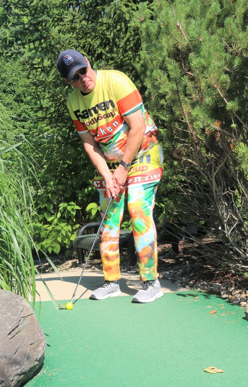 Firefighter/Paramedic Jim Emerton lines up his shot on hole 5, showing off some splashy attire.