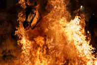 <p>A man rides a horse through flames during the annual “Luminarias” celebration on the eve of Saint Anthony’s day, Spain’s patron saint of animals, in the village of San Bartolome de Pinares, northwest of Madrid, Spain, Jan. 16, 2018. (Photo: Juan Medina/Reuters) </p>