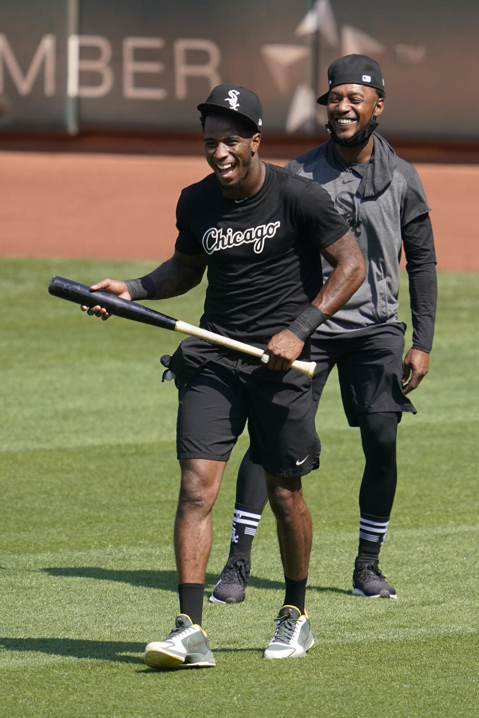 Chicago White Sox's Tim Anderson, left, laughs with Jarrod Dyson before a baseball workout in Oakland, Calif., Monday, Sept. 28, 2020. The White Sox are scheduled to play the Oakland Athletics in an American League wild-card playoff series starting Tuesday. (AP Photo/Jeff Chiu)