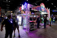 Attendees check out an LED display at the International Association of Amusement Parks and Attractions convention Tuesday, Nov. 19, 2019, in Orlando, Fla. (AP Photo/John Raoux)