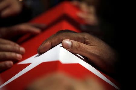 A hand rests on a coffin during a funeral service for victims of the thwarted coup at Fatih Mosque in Istanbul, Turkey, July 17, 2016. REUTERS/Alkis Konstantinidis