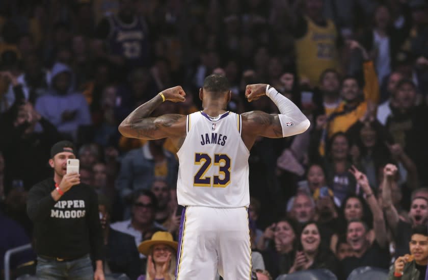 LeBron James flexes for the crowd during a game against the Hornets on Oct. 27 at Staples Center.