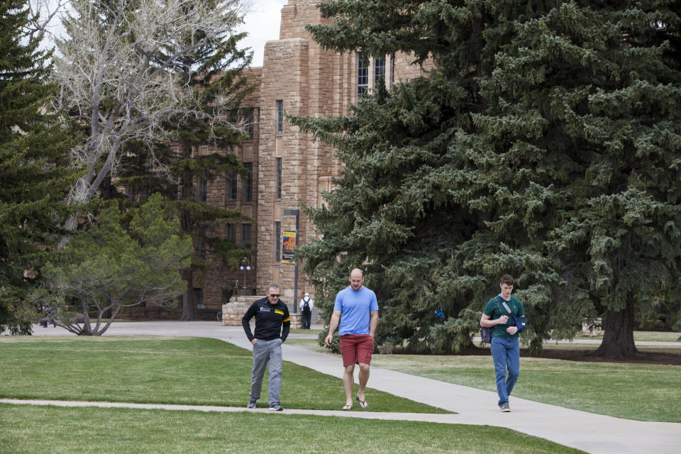 LARAMIE, WY - APRIL 30: Students walk across campus between classes at the University of Wyoming, on April 30, 2018 in Laramie, Wyoming. UW is a land-grant university, founded in March 1886 and opened in September 1887. The University of Wyoming is unusual in that its location within the state is written into the state's constitution. (Photo by Melanie Stetson Freeman/The Christian Science Monitor via Getty Images)