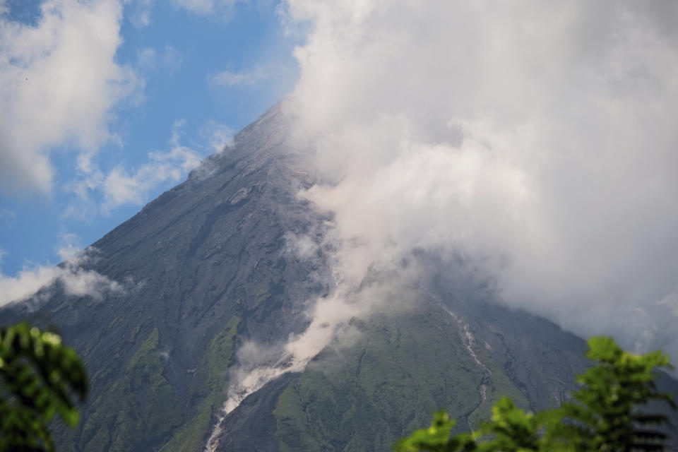 Mayon Volcano spews white smoke as seen from Daraga, Albay province, central Philippines on Thursday June 8, 2023. The Philippine Institute of Volcanology and Seismology raised Thursday the status of Mayon Volcano in Albay to Alert Level 3 due to "increased tendency towards a hazardous eruption." (AP Photo/John Michael Magdasoc)